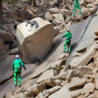 Two workers in Iran suddenly fell down while cutting a huge boulder and crushed one person. CCTV recorded the colleague trying to save him